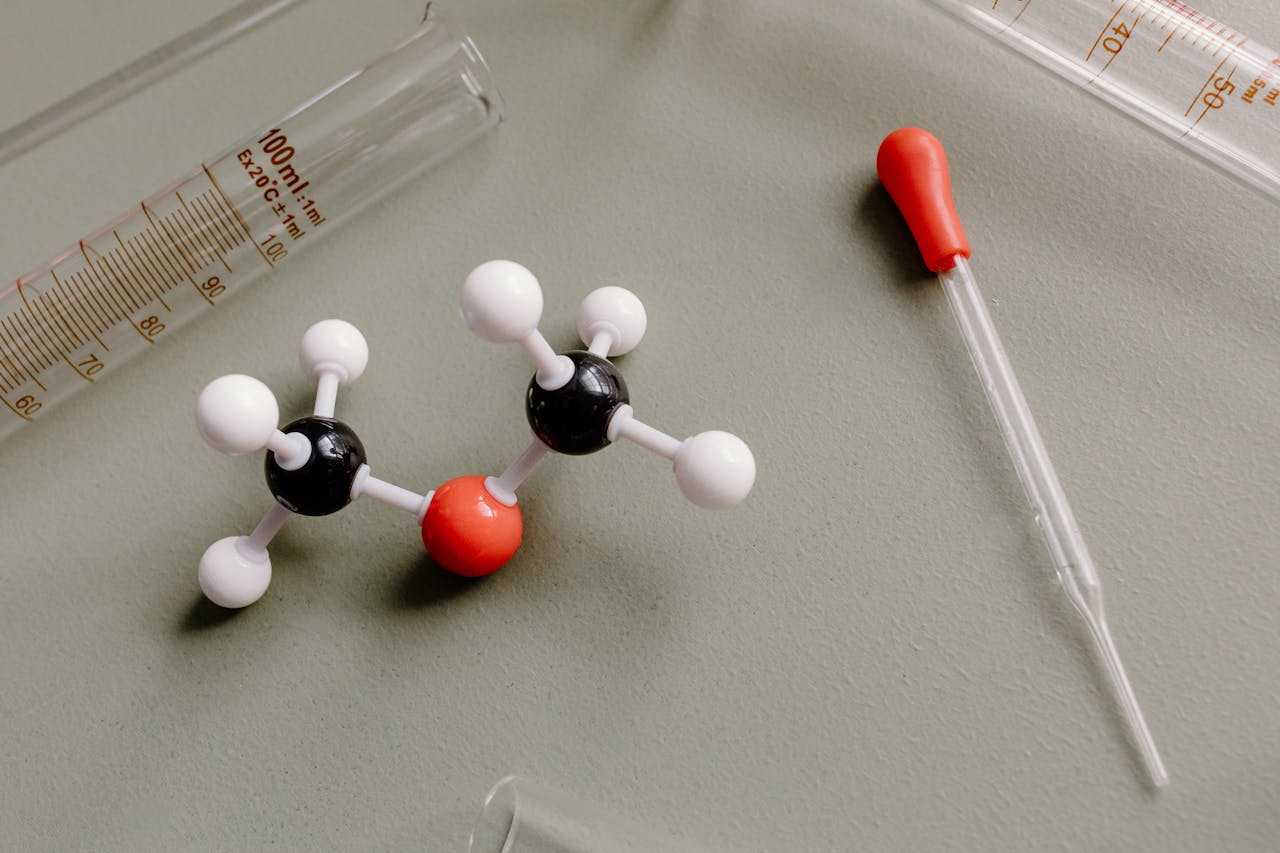 Close-up of laboratory equipment and molecular model on a flat surface.
